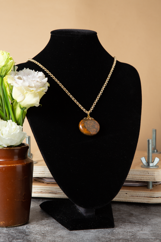 Brown Jasper pendant on a mid length gold chain.