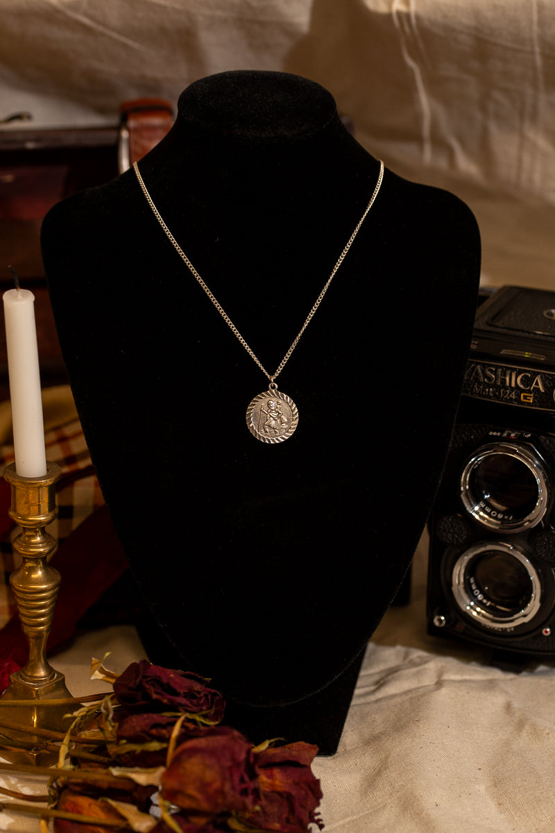 Round Sterling Silver St Christopher pendant on chain.