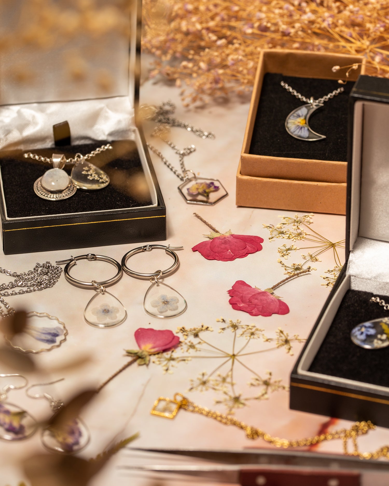 Array of handmade jewellery with the pressed flowers used to make them