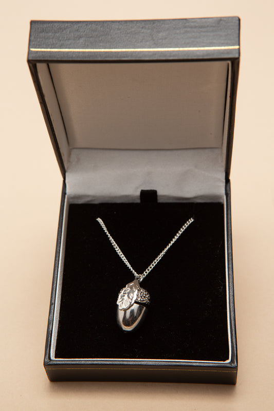 Silver acorn charm necklace with a tiny squirrel inside.