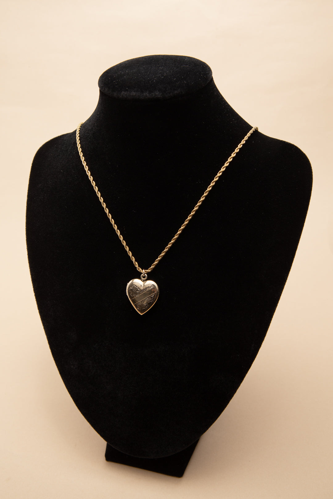 Rolled gold heart shaped locket on a rope chain