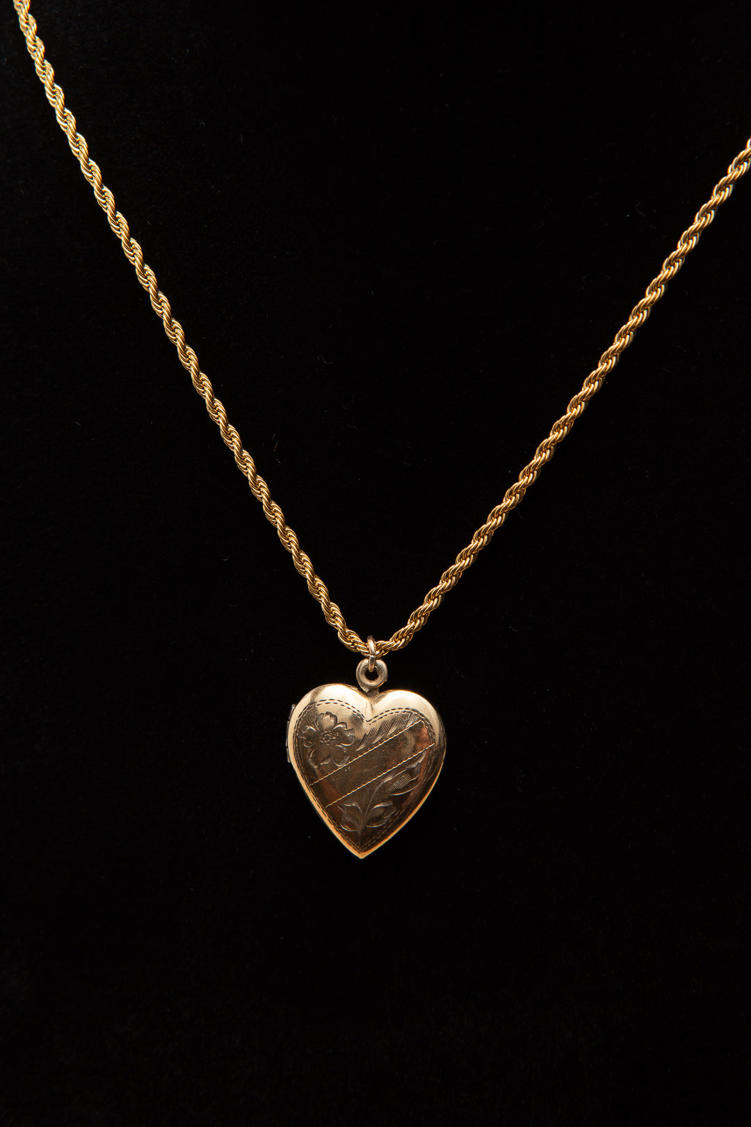 Rolled gold heart shaped locket on a rope chain