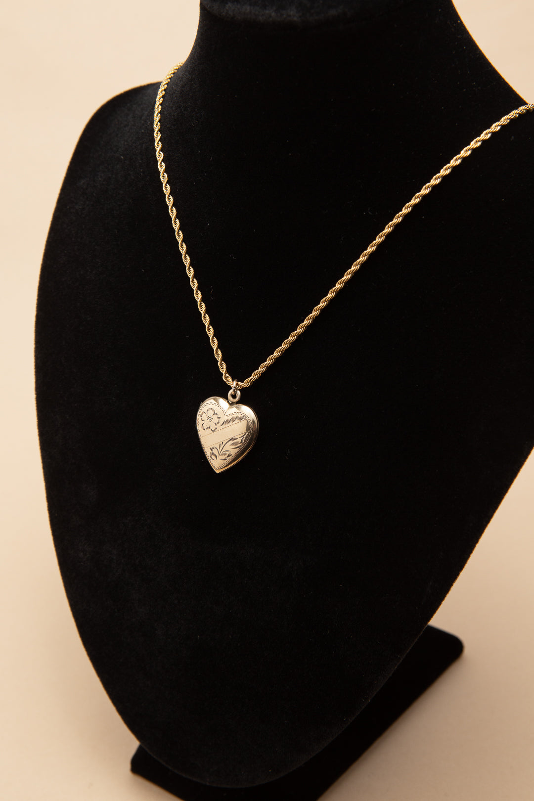 Rolled gold heart shaped locket on a rope chain